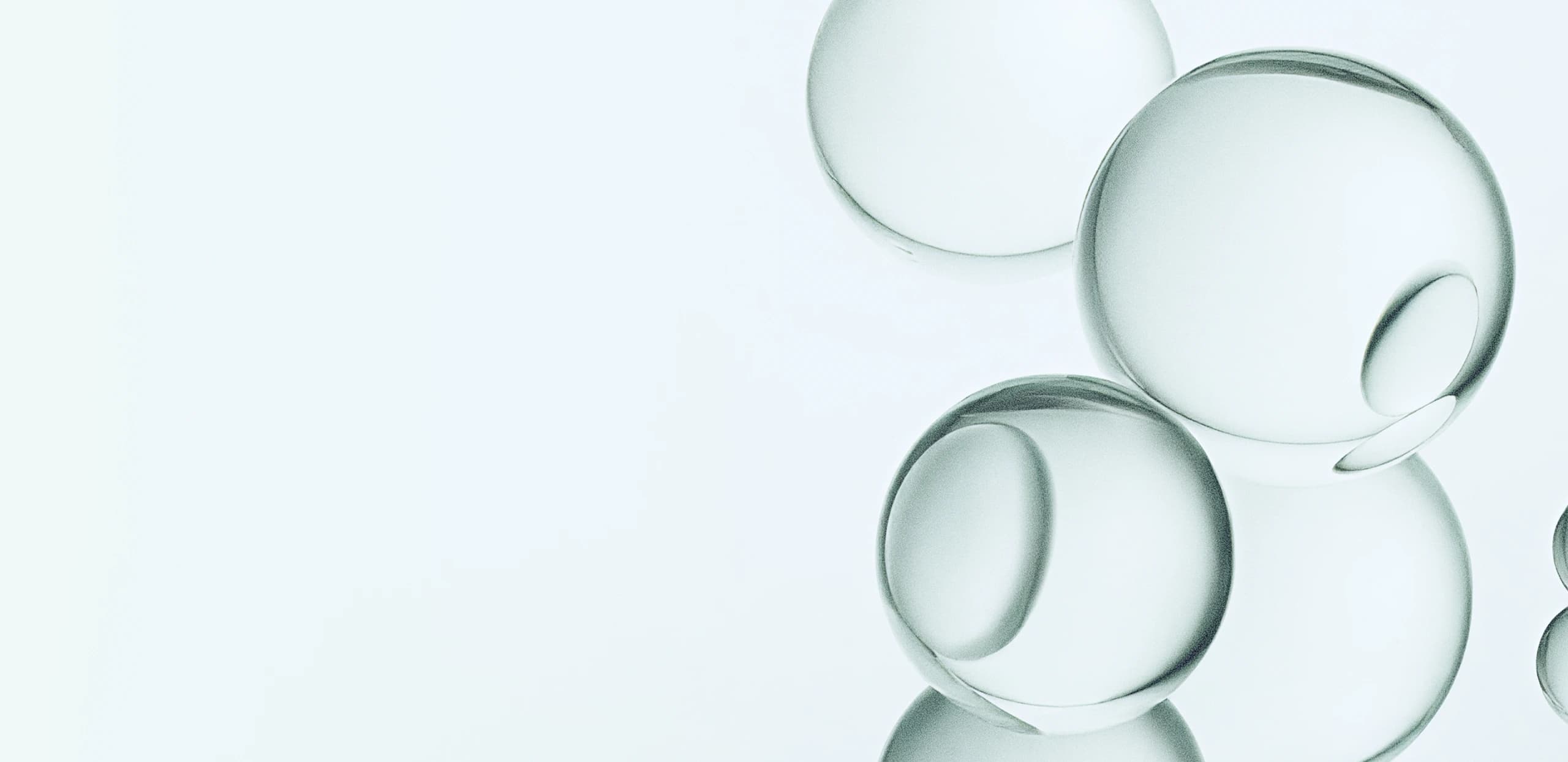 Close-up of translucent glass spheres with a soft, clean, and calming aesthetic