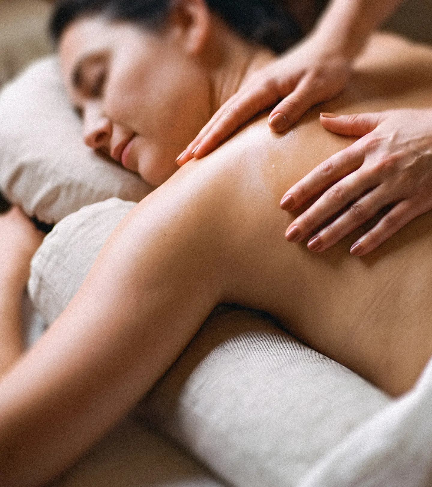 Therapist gently massaging a pregnant woman's back during a prenatal massage