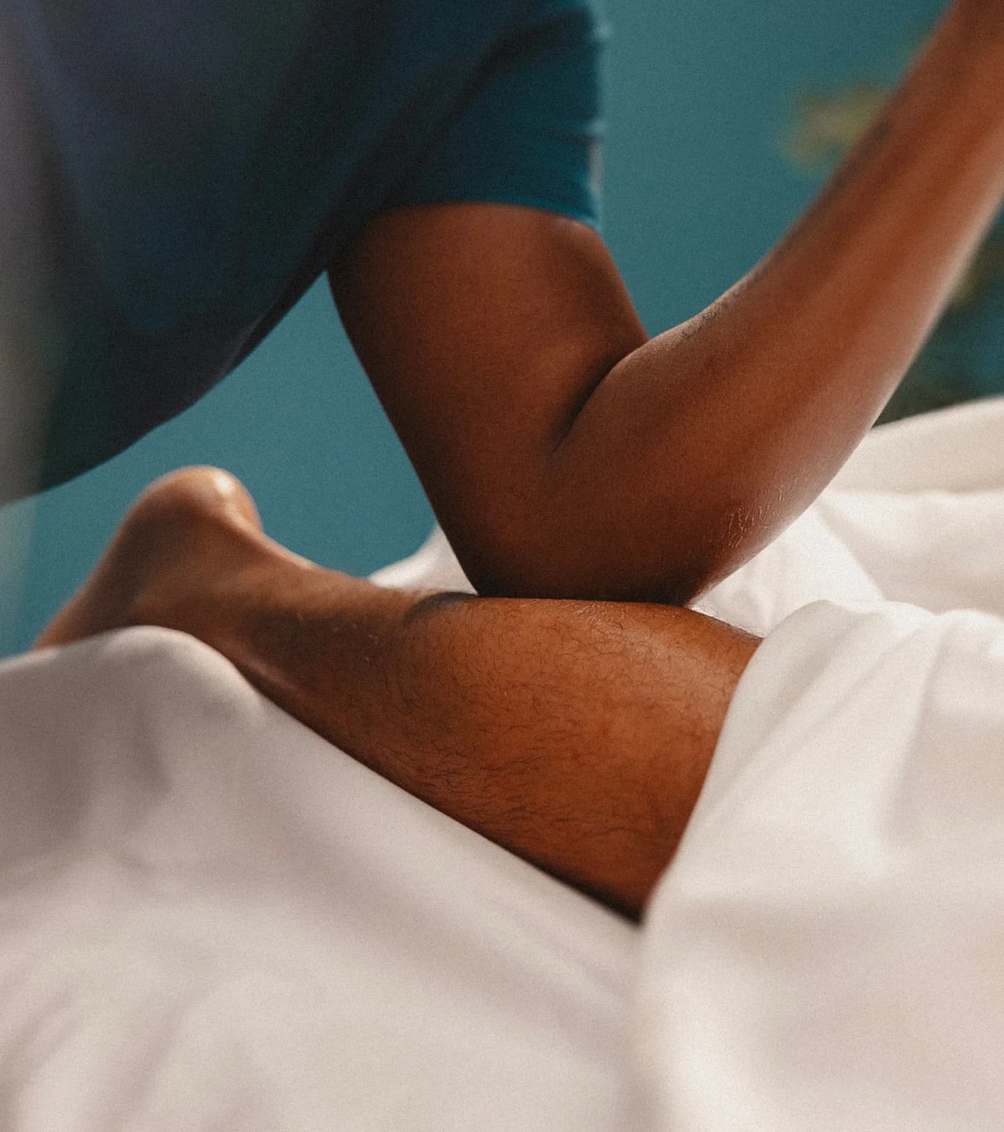 Therapist applying firm pressure to a client's upper back during a deep tissue massage