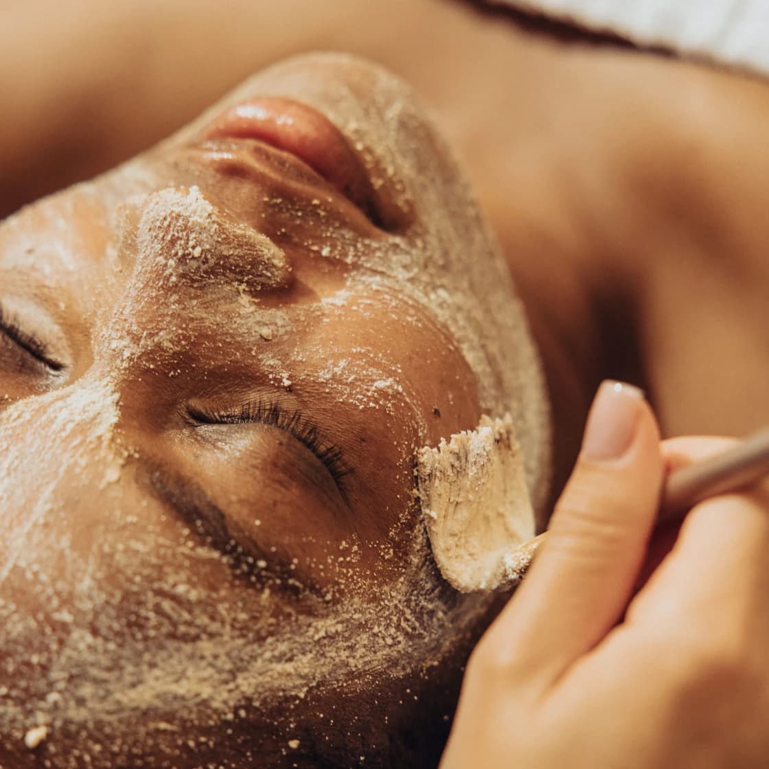Close-up of a client with a facial mask applied during a skincare treatment